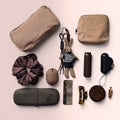 Flatlay of the Ultimate Mocha 11-Piece Purse Organizer Kit featuring corduroy pouches, silicone brush case, mini fan, and tortoise-shell hair accessories on a soft pink background.